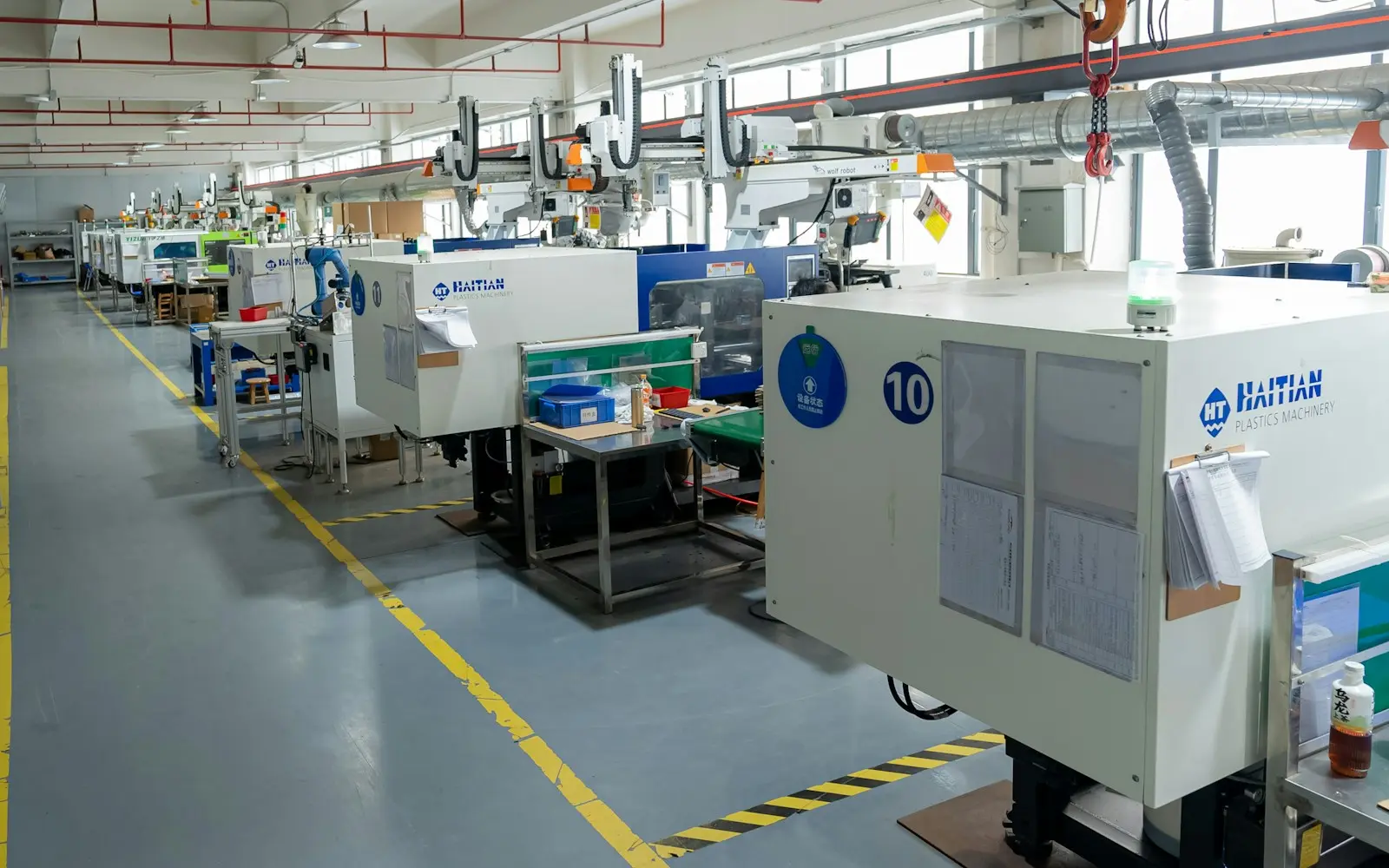 Row of injection moulding machines on a plastics shop floor
